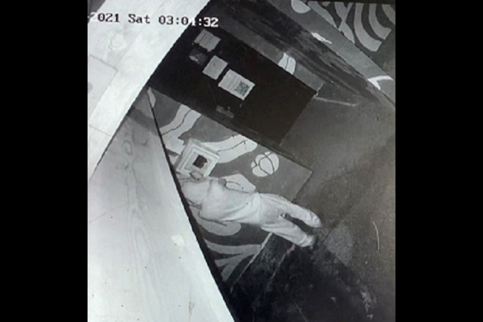 Sunshine Coast RCMP seeking “a male suspect, dressed in a light-coloured hooded track suit," caught on camera Nov. 27, 2021, stealing an AED. 