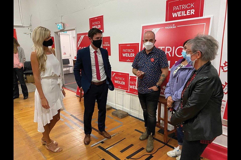 West Vancouver-Sunshine Coast-Sea to Sky Country Liberal incumbent Patrick Weiler, with partner Nicole Pedersen, talks to supporters at his election party on Sept. 20, 2021. 
