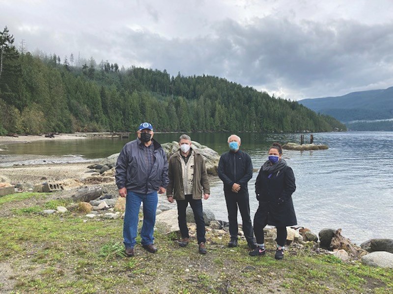 On site: hiwus Warren Paull of shíshálh Nation, Nicholas Simons, MLA for Powell River-Sunshine Coast & Minister of Social Development and Poverty Reduction, Murray Rankin, Minister of Indigenous Relations and Reconciliation, and hewhiwus Selina August of shíshálh Nation on a Nov. 12 tour of shíshálh swiya.