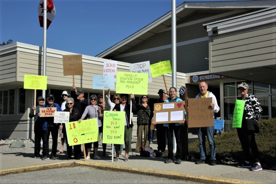 Protesters gathered outside the Sunshine Coast Regional District office on May 11 to voice their opposition to a community hall at Connor Park.