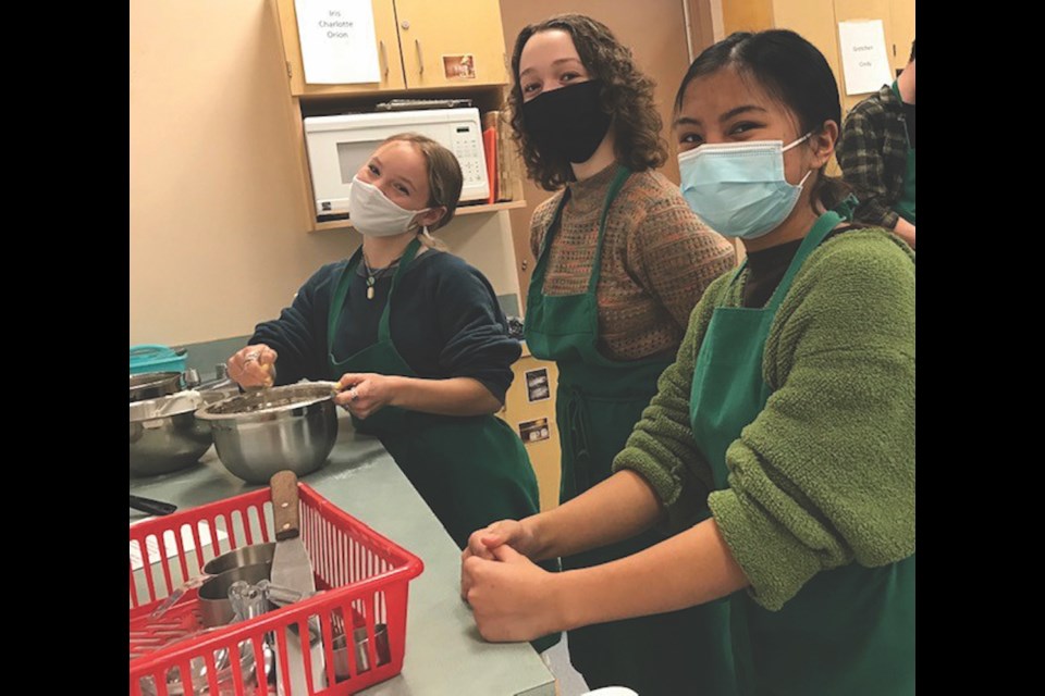 Molly, Kaliana and Florence prepping ingredients for pierogies.