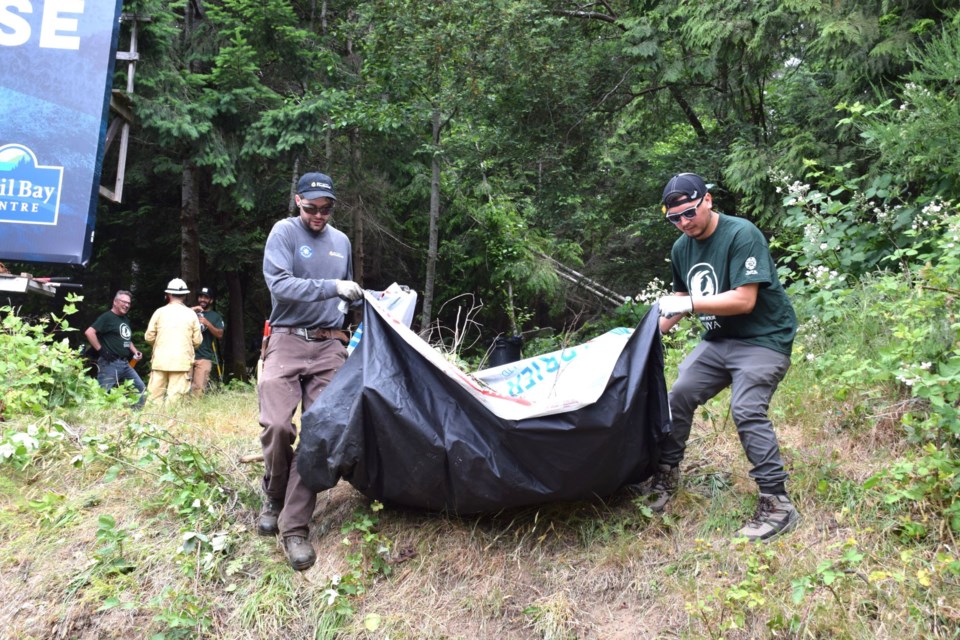 Volunteers helped cleanup brush and debris as part of a fire mitigation cleanup outside shíshálh Nation longhouse. 