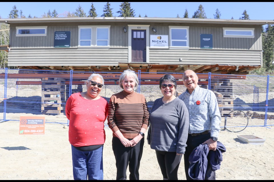 shíshálh Nation Councillor Rochelle Jones, lhe hiwus yalxwemult (Chief Lenora Joe), Councillor Raquel Joe and Councillor Keith Julius pose in front of one of two homes that have arrived to Selma Park. 