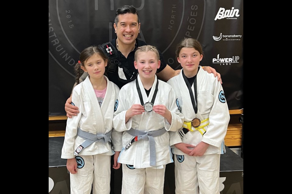 Mariko Hatanaka (10), Emma Kingsley (11), Jayden Stark (12) with coach Sean Hatanaka