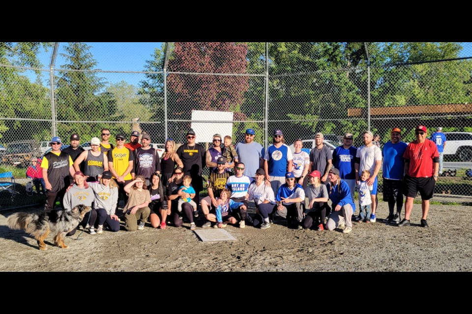 Inaugural slo-pitch softball alumni game group photo at Kinnikinnick Park, May 31.