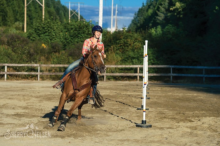 Kayla Zogas riding her mare Zeta in Pole Bending race.