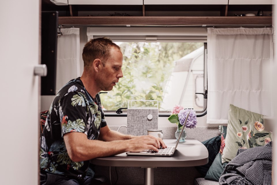 Man in RV working on computer