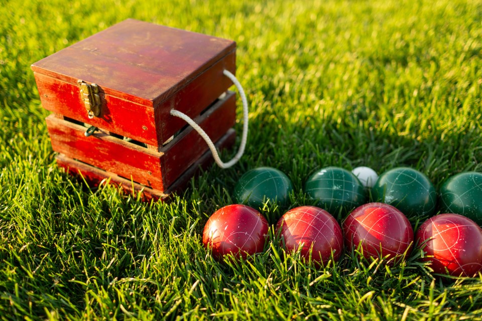 Bocce ball set with balls and case setup on lawn