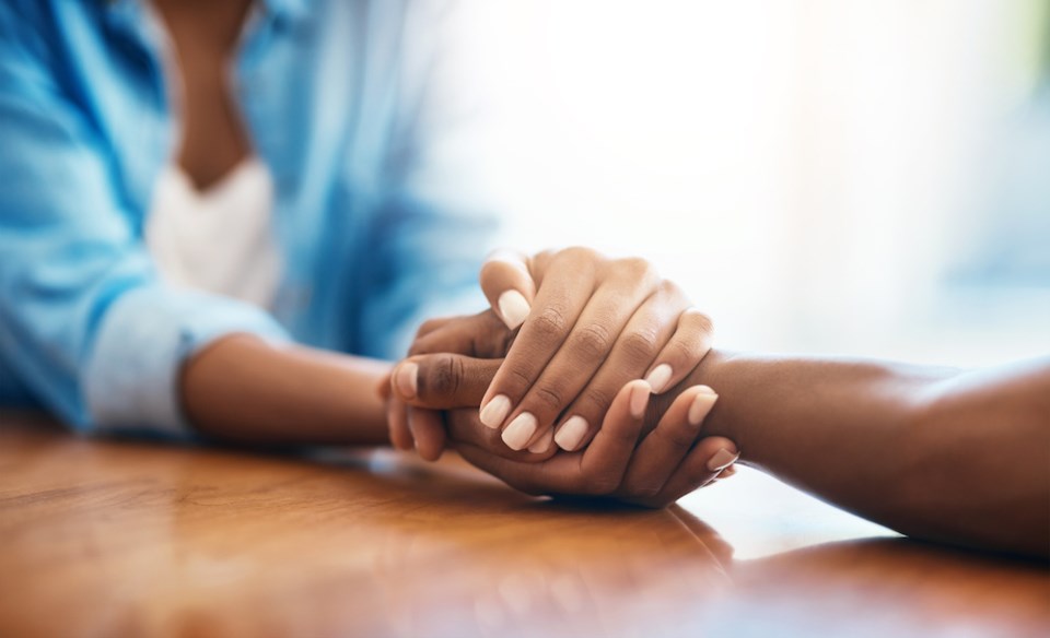 closeup-shot-of-two-unrecognizable-people-holding-hands-in-comfort-at-home