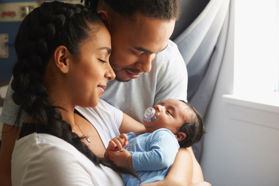 Couple cradling newborn baby