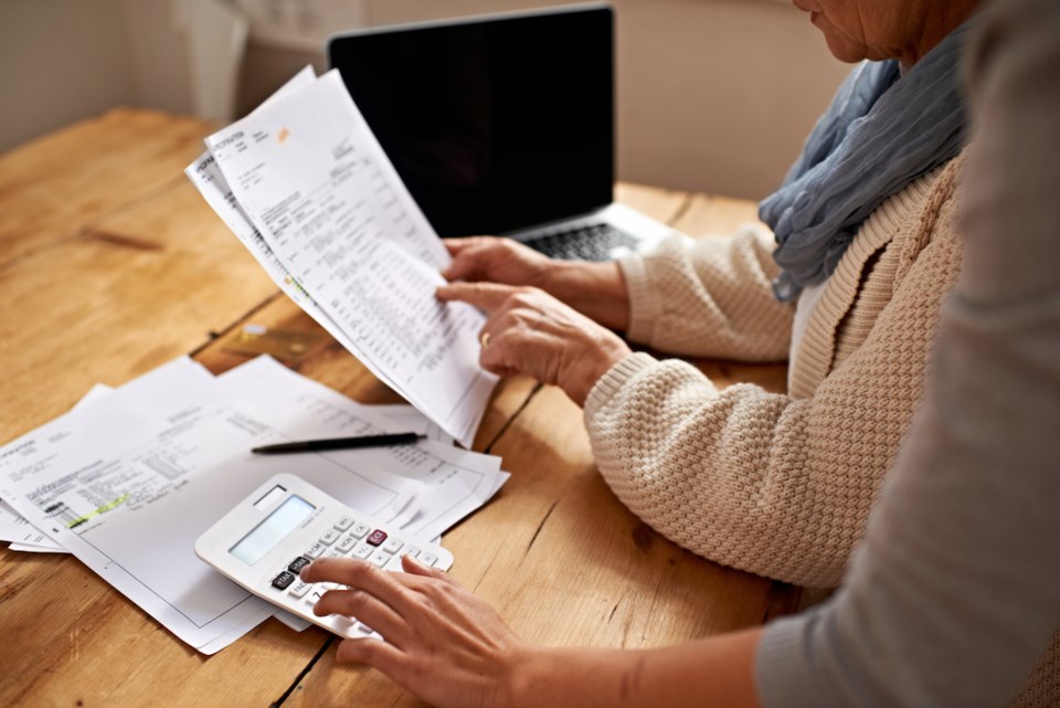 Cropped view of a senior woman receiving help with her finances from her granddaughter