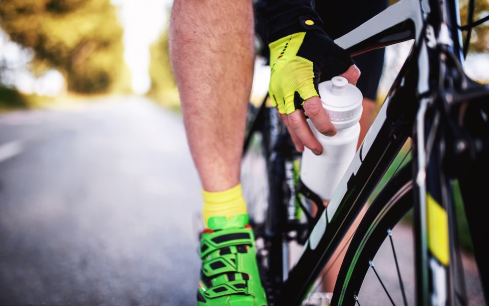 cyclist-with-water-bottle-on-roadway