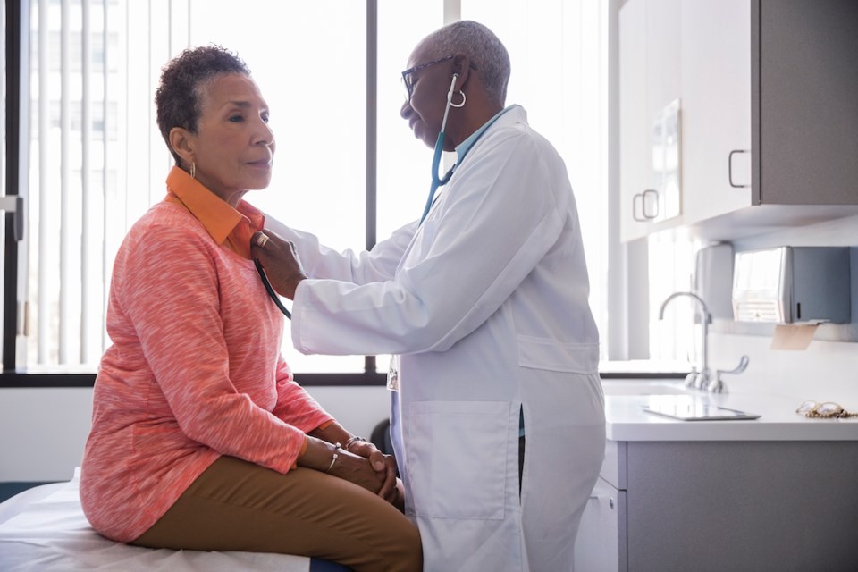 Doctor using a stethoscope on a patient