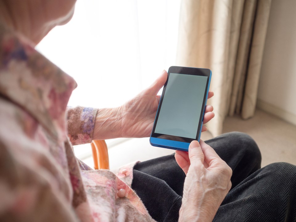Elderly woman holding a smart phone
