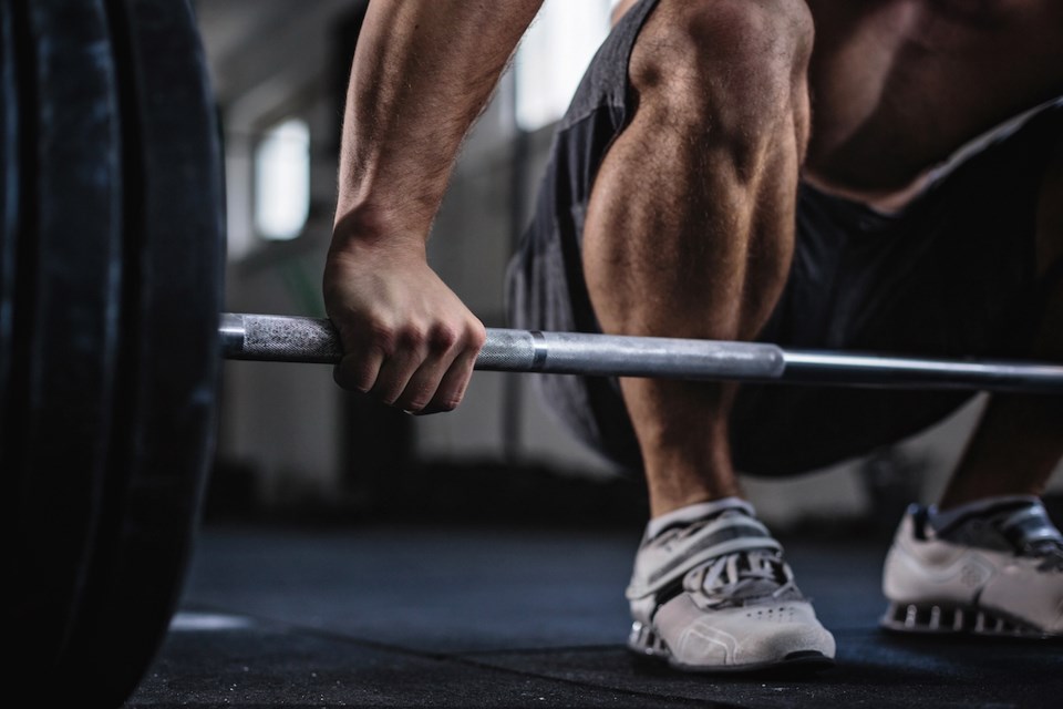 Exercising with barbell in the gym