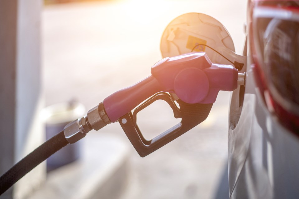 Fuel oil gasoline dispenser at petrol filling station.Holding fuel nozzle to refuel gasoline for car.