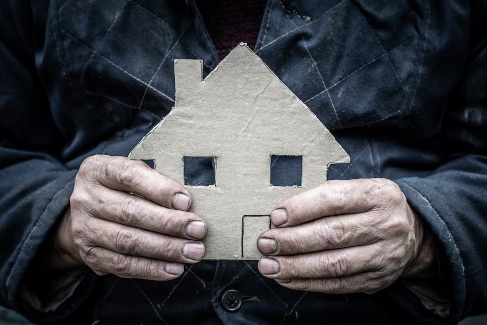 male-worker-he-is-holding-a-house-cut-out-of-cardboard