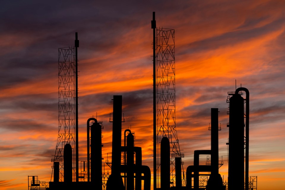Oil refinery plant of petroleum or petrochemical industry production at sunset