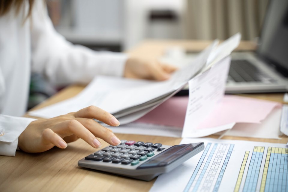 Person typing on a calculator - budget work - accounting