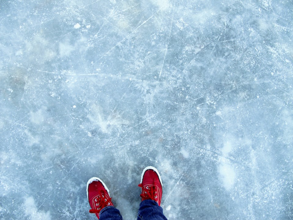 red-shoes-standing-on-thin-cracked-ice-of-outdoor-rink