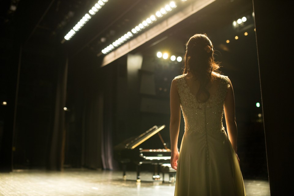 Woman looking at grand piano