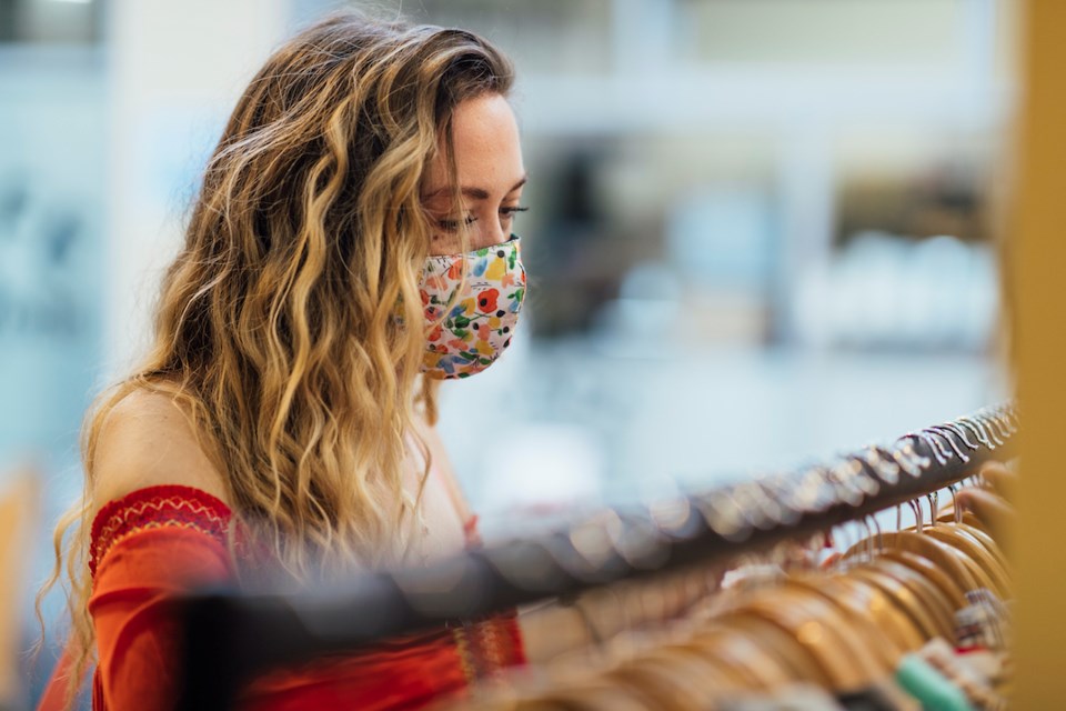 Young woman looking through clothing