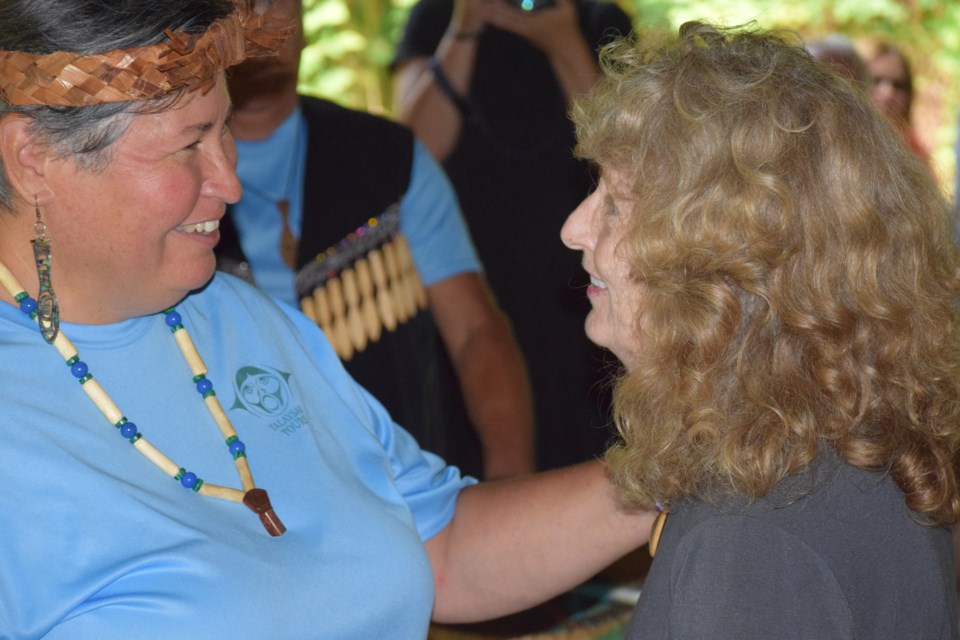 Ming Neil (right) receives a hug of farewell from Talasay Tour's Xets’emits’a (Candace Campo) at an event celebrating Ming's retirement from the B.C. Parks service