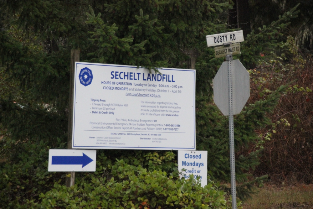 A sign for the Sechelt Landfill is shown next to a street sign for Dusty Road.