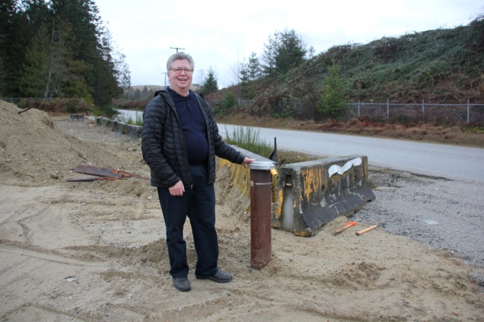 Sechelt mayor John Henderson published his personal view that a well needs to be drilled at Dusty Road — immediately. This photo, taken Jan. 13, shows Henderson with the test well. 