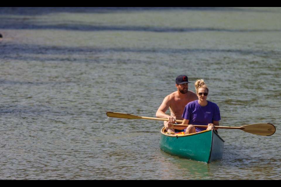 Pat G and Karis G canoe on Ghost Lake on Saturday (May 16). (Chelsea Kemp/The Cochrane Eagle)