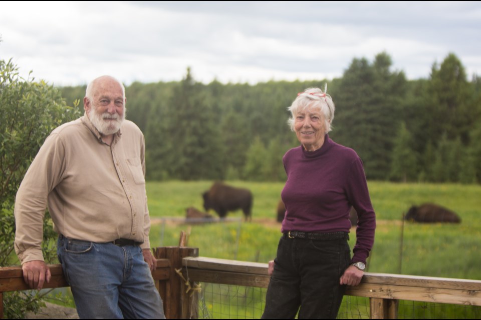 Cochrane Ecological Institute director Ken Weagle, left, and president Clio Smeeton stand in front of their buffalo hold on Saturday, June 27, 2020.CHELSEA KEMP COCHRANE EAGLE PHOTO