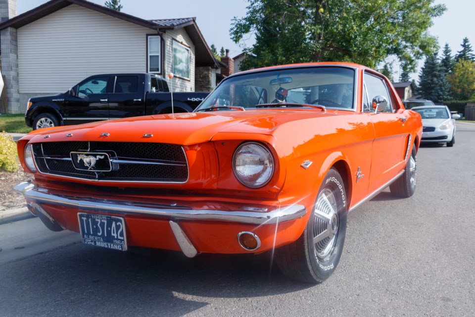 Tom Cropper's poppy red 1964.5 Mustang on Thursday (Sept. 17). (Chelsea Kemp/The Cochrane Eagle)