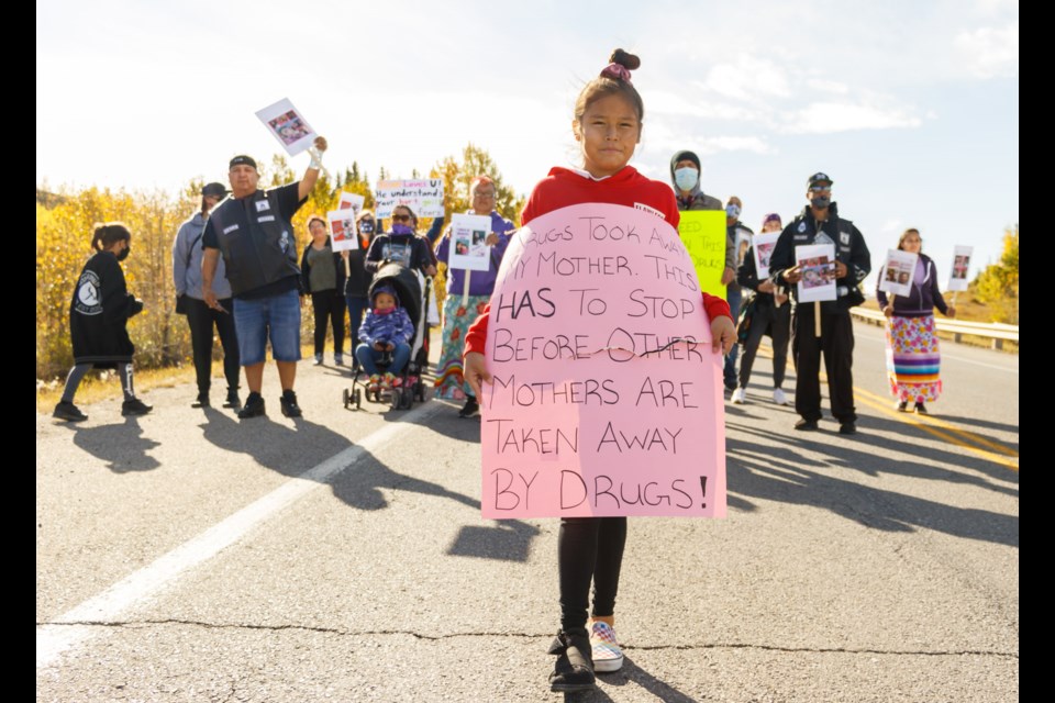 Kallie Powder, who lost her mother Christa-Lee to an overdose, leads a march down Morley Road during the Addictions Awareness Walk in Stoney Nakoda First Nation on Saturday, Sept. 26, 2020. (Chelsea Kemp/The Cochrane Eagle)