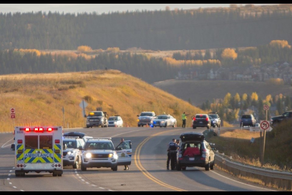RCMP investigate a fatal collision involving a cyclist and a SUV on Highway 22 just North of Cochrane on Wednesday (Sept. 30). (Chelsea Kemp/The Cochrane Eagle)