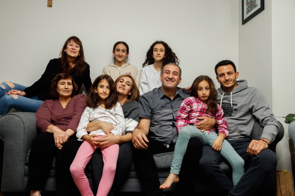 The Kadmous family poses for a photo in their home on Friday (Nov. 6). (Chelsea Kemp/The Cochrane Eagle)