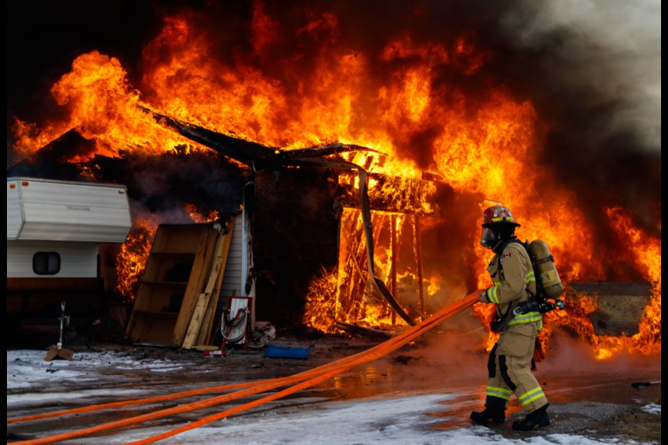 Cochrane Fire Services contain a garage fire in West Valley on Saturday (Nov. 15). (Chelsea Kemp/The Cochrane Eagle)