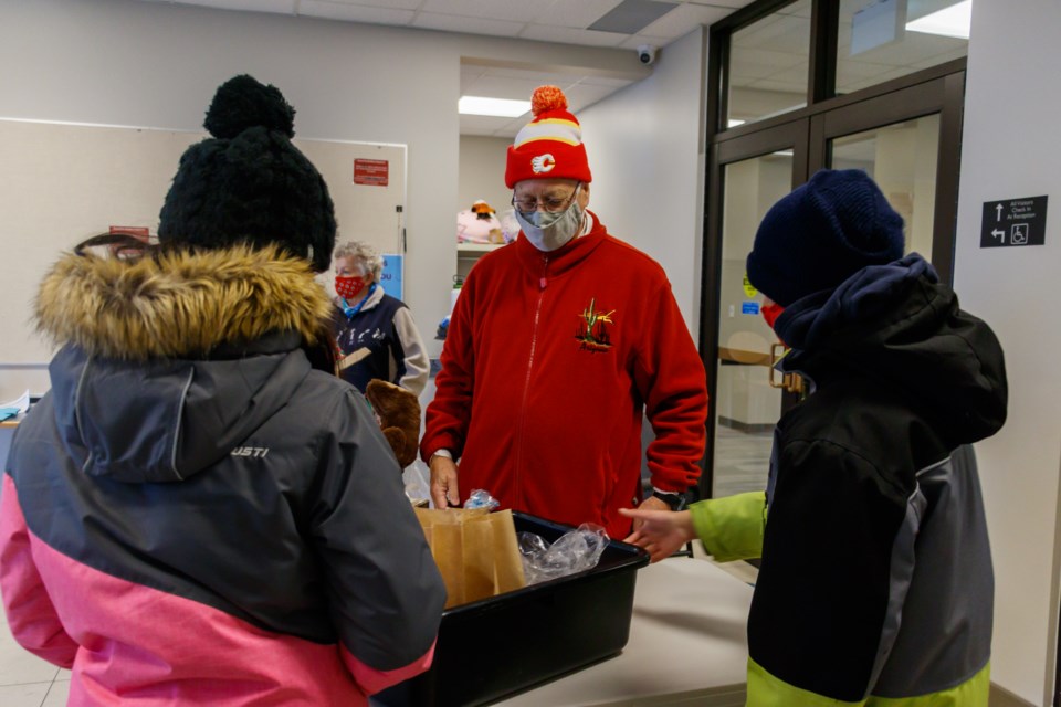 Chris and Joan Logan hand out soup deliveries at the third annual Jingle Mingle in the Cochrane Alliance Church parking lot on Friday (Dec. 25). (Chelsea Kemp/The Cochrane Eagle)