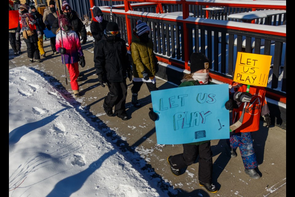 Ralliers make their way down from the Cochrane Arena to the Spray Lake Sawmills Family Sports Centre during the Let Them Play walk on Sunday (Feb. 7). (Chelsea Kemp/The Cochrane Eagle)