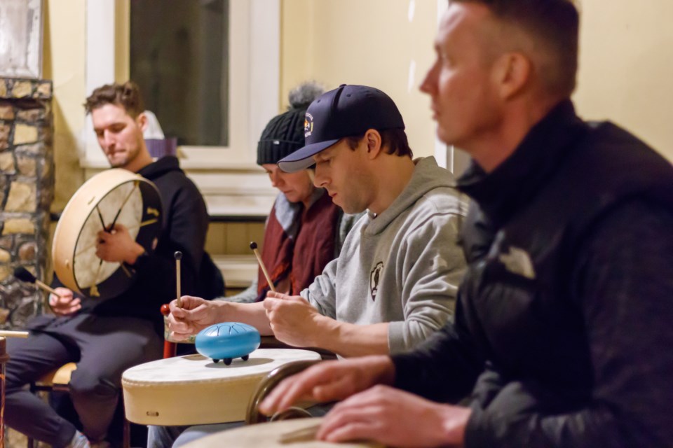 Martin Medynski, left, Tara Funk, Troy Treit and Kurt Stenberg plays the drums during the Drumming Circle with Marilyn therapy program at Wayfinders Wellness Retreat on Friday (Feb. 26). (Chelsea Kemp/The Cochrane Eagle)