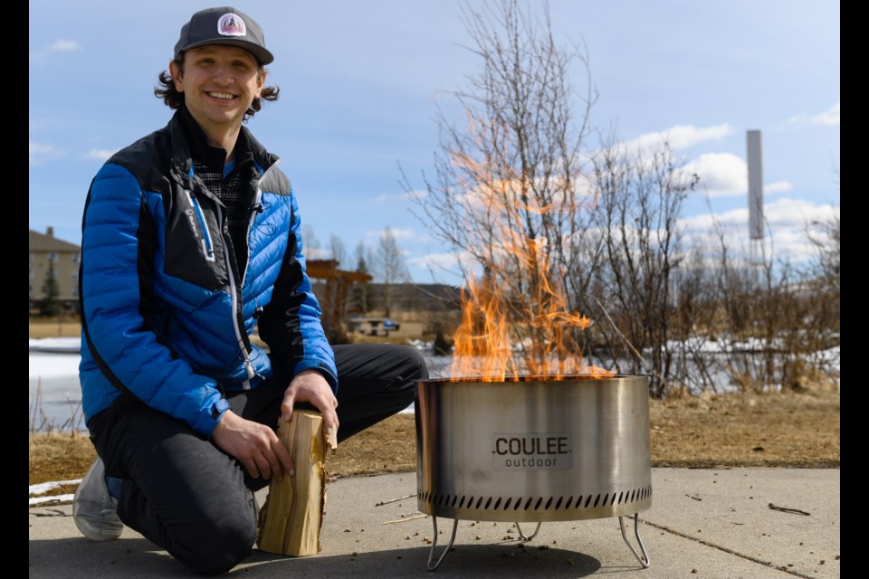 Dexter Hamilton of Coulee Outdoor poses beside one of his smokeless firepits at Mitford Ponds in Cochrane on March 27, 2021. (File Photo/Cochrane Eagle)