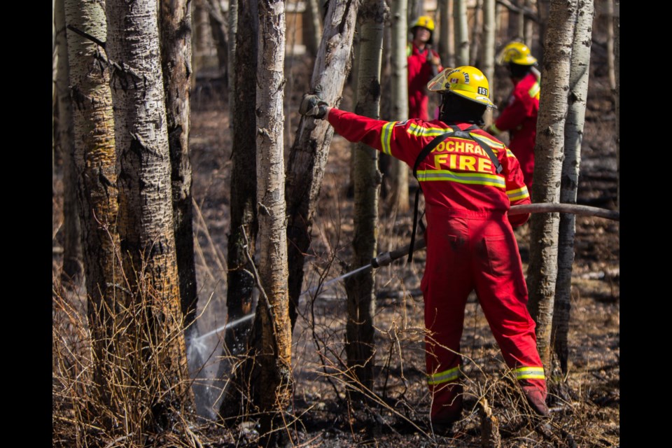 Cochrane Fire Services members contain a grass fire near River Heights on Wednesday (April 28). (Chelsea Kemp/The Cochrane Eagle)