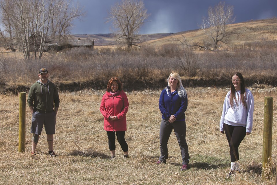 Wayfinders Wellness Retreat Volunteers Donnie Hall, left, Lora Weir, Chelsea McPherson and Erica Koster pose for a photo at the ranch on Sunday (April 2). (Chelsea Kemp/The Cochrane Eagle)