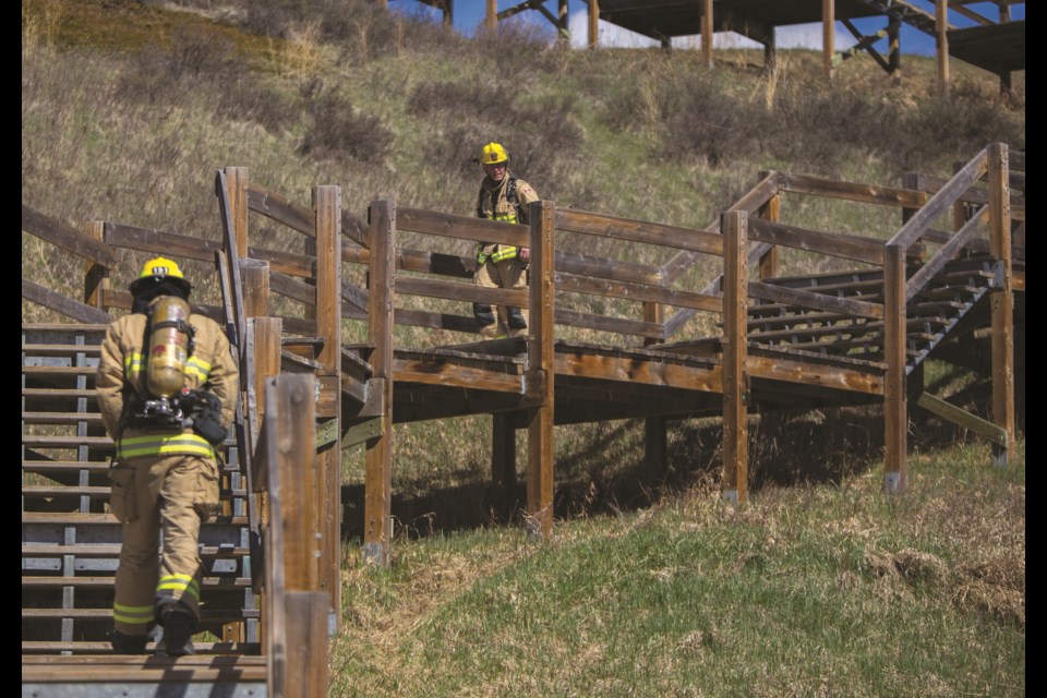 Cochrane Fire Servicesâ members Andrew Weaver and Matthew Cameron participate in the Firefighter Stairclimb Challenge on Friday (May 14) at the Cochrane Ranche stairs. (Chelsea Kemp/The Cochrane Eagle)