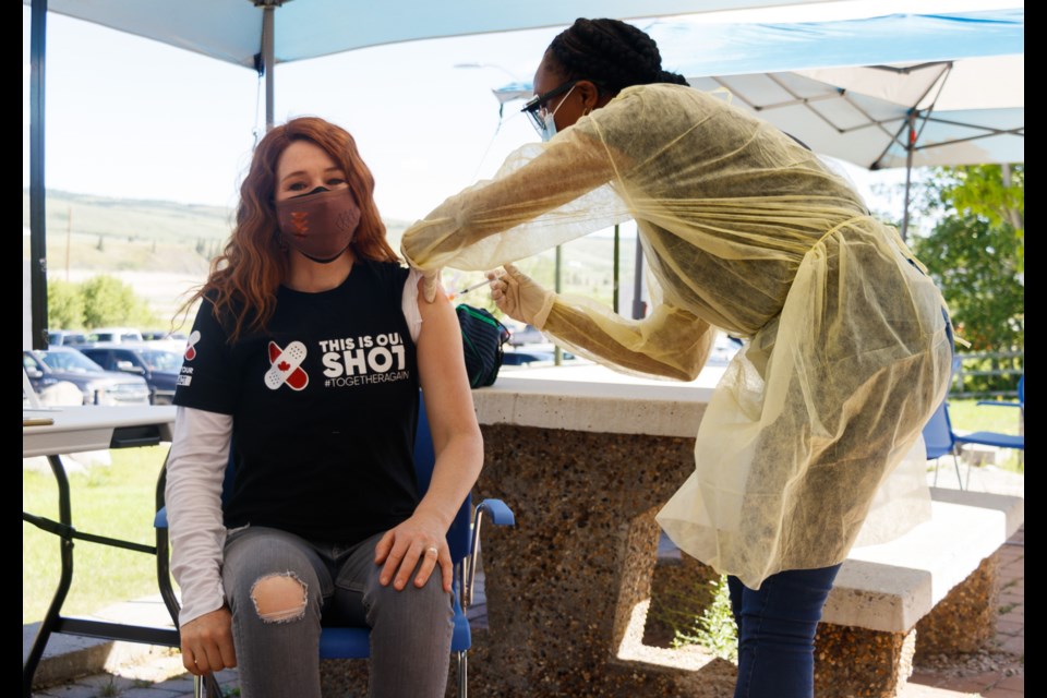 Canadian Olympian Clara Hughes receives the second dose of the COVID-19 vaccine from nurse Ritche Holm at a Stoney Health Services community vaccination clinic in partnership with This is Our Shot on Thursday (June 17) in Stoney Nakoda First Nation. (Chelsea Kemp/The Cochrane Eagle)