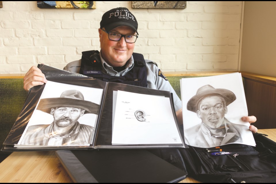 Cst. Nathan Moore shows off his work as a sketch artist on Thursday, July 29, 2021. (Chelsea Kemp/The Cochrane Eagle)