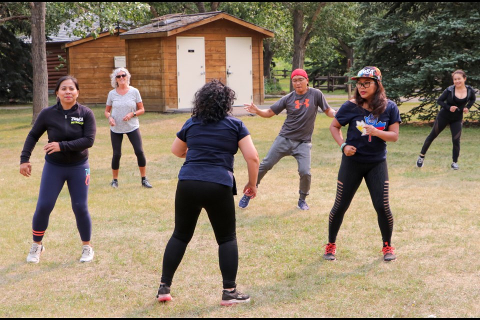 Maria Luisa Moreno of M2Z DanZfit Club, centre, leads Zumba in the Park with fellow instructors Rhonda Oriel Go, left, and Farah Jay Gadingan, right, at Cochrane Ranche on Saturday (Aug. 7). The event was in cooperation with the Filipino-Canadian Association of Cochrane Alberta. (Jessica Lee/The Cochrane Eagle)