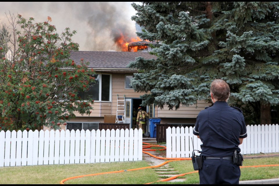 Cochrane Fire Services and a crew from Rockyview County respond to a house fire on Baird Avenue in East End on Sunday (Aug. 21) afternoon. Cochrane RCMP and EMS were also on scene. (Jessica Lee/The Cochrane Eagle)
