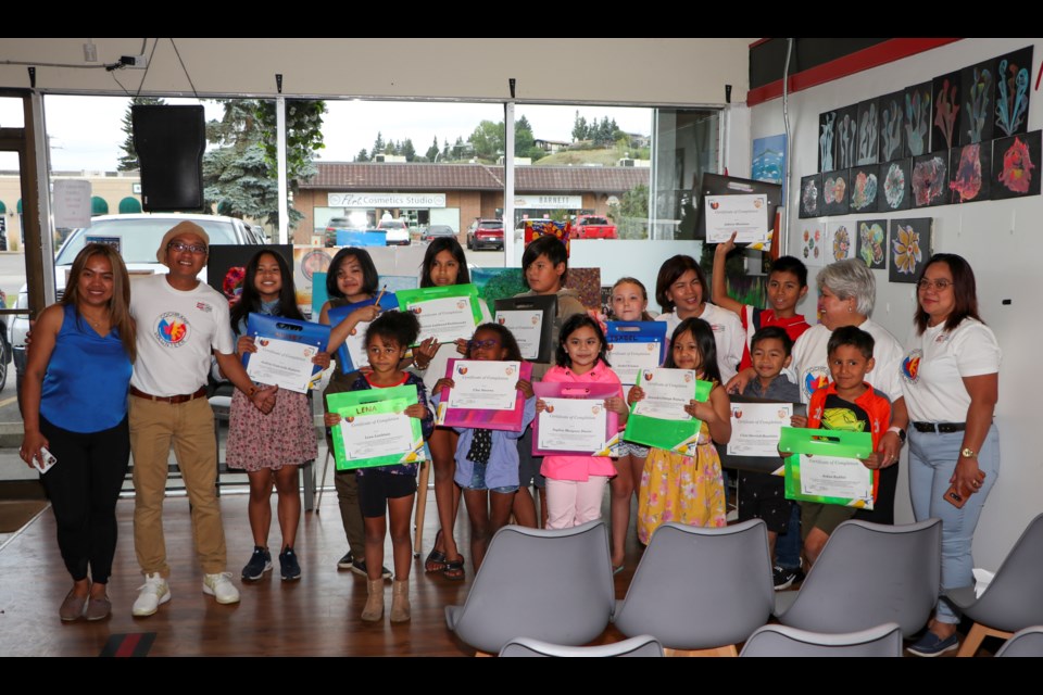 Members of the Filipino Canadian Association of Cochrane Alberta (FCACA) and students of the Kids Summer Art Workshop pose for a group photo at their wrap-up ceremony at Bubble Tea Brewers on Tuesday (Aug. 31). The five-week long workshop was organized by the FCACA with sponsorship from Cochrane Home Treasures. (Jessica Lee/The Cochrane Eagle)