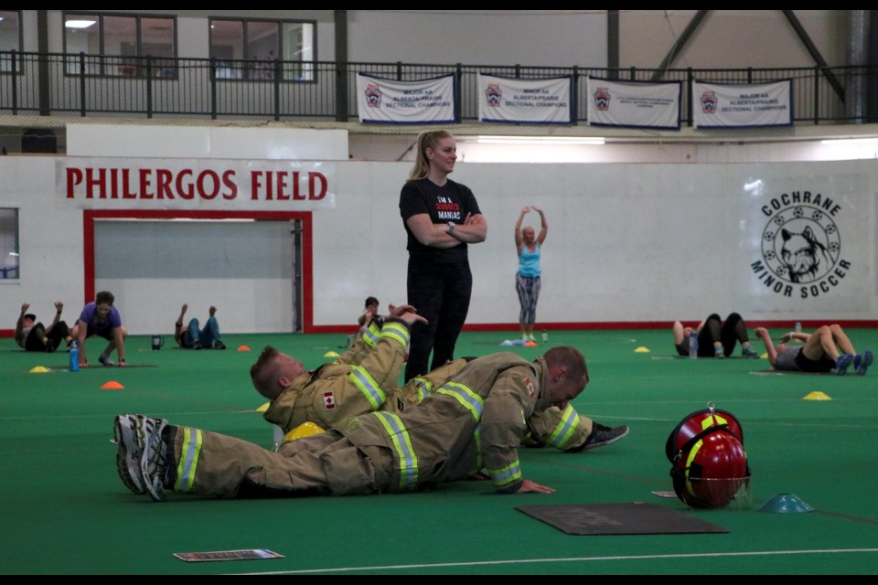 First responders and others exercise to pay tribute to the 412 fallen first responders of the September 11, 2011 terrorist attacks at the 6th annual 9/11 Memorial Workout at Spray Lakes Sawmill Family Sports Centre on Friday (Sept. 10). (Jessica Lee/The Cochrane Eagle)