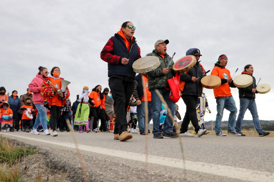 A band of Stoney Nakoda First Nation drummers lead people on a walk from the McDougall Memorial United Church to the Morley United Church to raise awareness for residential school survivors and non-survivors on Sept. 30, the first annual National Day for Truth and Reconciliation. (Jessica Lee/The Cochrane Eagle)